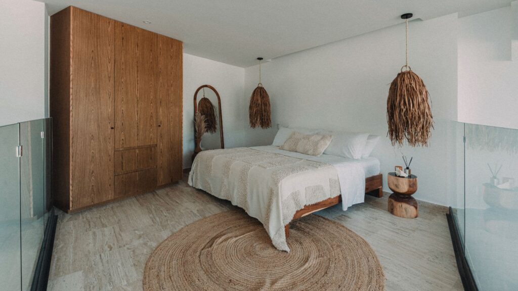 Elegant bedroom in LENEVA LOFT, Tulum, with king-sized bed and jungle views.