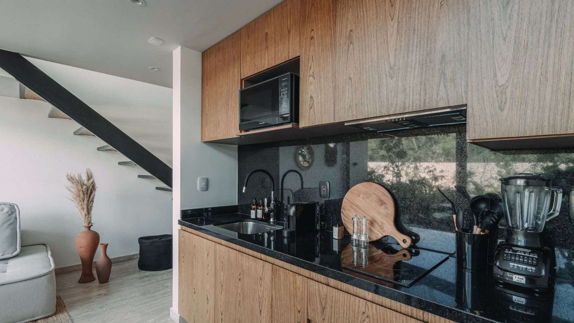 Modern kitchen in LENEVA LOFT, fully equipped with appliances and sleek countertops.Accommodation in Tulum.