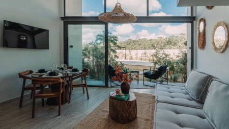 Relax in this airy, open-concept living room with modern decor, natural light, and direct access to the lush outdoor terrace. Perfect for unwinding after a day in Tulum.